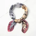 Close-up of printed silk scarf with peony sketch pattern tied on a white shirt - Pink Trim