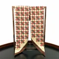 Detail of 90cm twill silk scarf with interlocking geometric patterns and hand-rolled edges - Coffee