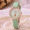 Close-up of mint green leather strap watch with rose gold cat silhouette dial design - Green