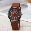 Close-up of brown silicone strap and black metal casing on men's sport quartz watch - Coffee