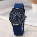 Detail view of the blue silicone strap and black metal casing of the quartz watch - Blue