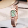 Detail of rose gold oval watch face with mint green dial and Roman numerals - Green Dial