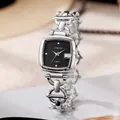 Detail of silver square watch with black dial and decorative hollow metal chain strap - Gold Band Black Dial