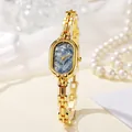 Elegante goldene Damenquarzuhr mit blauem Marmorzifferblatt und Perlen-Accessoires - Goldarmband Blaues Zifferblatt