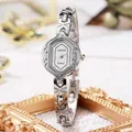 Vintage silver quartz watch for women featuring unique oval case and engraved strap - Silver Band White Dial