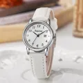 Macro shot of silver women's watch featuring white leather strap and date display - White Strap Silver Case White Dial