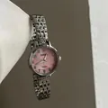 Detail of silver steel watch featuring a pink pearlescent dial and black Arabic numerals - Gradient Pink