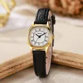 Detailed macro view of the oval gold watch case and black leather strap with embossed texture - Black Band Gold Case White Dial