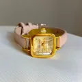 Detail view of square gold quartz watch case with minimalist dial and pink leather strap - Pink