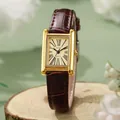 Vintage square women's watch with champagne dial and brown leather strap on wooden stand - Brown Strap - Gold Case Gold Dial