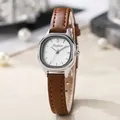 Detail of tonneau-shaped silver alloy watch case with white dial and brown leather strap - Brown Strap Silver Case White Dial