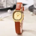 Retro tonneau gold watch with brown leather strap and champagne dial on a pearl background - Brown Strap Gold Case Gold Dial
