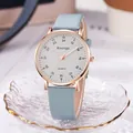 Detail of rose gold quartz watch with light blue leather strap on golden wavy glass - Blue Strap White Dial