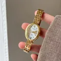 Detailed view of women gold oval quartz watch with elegant chain strap and white dial face - Gold Steel Strap White Dial