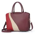 Detail of color-block burgundy leather tote bag with white stitching and gold hardware - Burgundy