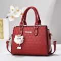 Deep red Boston shoulder bag with triangular embossed texture and white plush charm - Wine Red