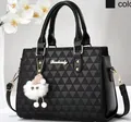 Detail of black crossbody bag featuring triangle woven texture and golden brand logo - Black