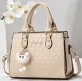 Detail of beige geometric embossed handbag with soft sheep plush charm and shoulder strap - Off-white