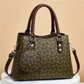 Détail du sac seau vert olive avec imprimé monogramme et petit porte-monnaie rond assorti - Sac à Main et Pochette / Vert