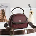 Burgundy multi-pocket handbag with textured pattern and wide brown strap - Red