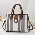 Detail of woven bicolor handbag with brown leather trim and golden diamond rotary lock - White Blue Chain Print