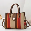 Large woven tote bag with colorful vertical stripes and brown leather trim details - Wine Red