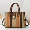 Vertical striped oversized tote bag with brown leather handles and gold buckle - Khaki