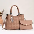 Detail of khaki quilted tote bag set featuring leaf charm and pearl accents with clutch - Pink