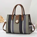 Large capacity striped tote bag with brown leather trim and golden twist lock - Green