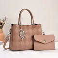Detail view of pink tote and envelope bag set with faux leather lychee texture and leaf charm - Pink