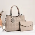 Chic beige quilted tote bag and matching clutch set with a metallic leaf pendant detail - Khaki