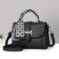 Chic black litchi pattern leather handbag with silk scarf handle and silver buckle detail - Black
