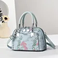 Elegant shell-shaped handbag with vintage floral embroidery and grey-blue leather handles - 22x10x15cm / Blue