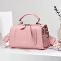 Pink lychee leather crossbody bag with geometric woven strap and silver hardware - Pink