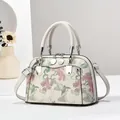 Detailed view of jacquard floral pattern and fine stitching on the retro handbag - 22x10x15cm / Off White
