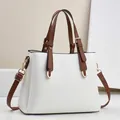 Elegant white lychee-grain PU leather handbag with brown handles and gold hardware - 28cm x 11cm x 22cm / White