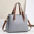 Detailed close-up of light gray pebbled leather texture with golden hardware on a tote bag - 28cm x 11cm x 22cm / Gray