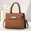Close-up of brown litchi pattern leather tote bag with elegant gold twist lock hardware - 28cm x 11cm x 22cm / Khaki/Earth Yellow