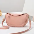 Pink lychee grain leather crescent shoulder bag with golden hardware accents - Pink