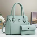 Detail of mint green lychee textured leather tote bag with matching envelope wallet - Green