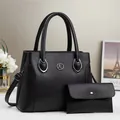 Detailed view of black litchi pattern handbag set with adjustable strap and K logo - Black