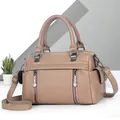 Detail of soft faux leather satchel bag with vertical zippers and side pocket details - Khaki