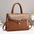 Brown glossy faux leather handbag with crocodile pattern and golden hardware strap - Earthy Yellow