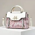 Retro hand bag with Chinese cloud embroidery and golden swan clasp on a white pedestal - L23 W11 H18 / Off White