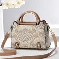 Ethnic pattern crossbody bag with blue waves and gold hardware on white background - Khaki