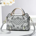Silver shoulder bag with wave pattern and metallic handle for a minimalist look - Silver
