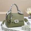 Green leather handbag with G buckle, scarf handle, and geometric patterned strap - Green