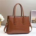 Brown crocodile embossed tote bag with gold hardware and a detachable shoulder strap - Brown
