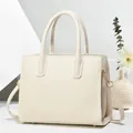 Borsa tote crema goffrata a righe con doppi manici e dettagli in metallo dorato lucido - Bianco Sporco