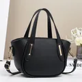 Fashionable black lychee grain mini crossbody bag with gold hardware and dual handles - Black